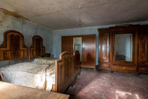 Bedroom with double bed and wardrobe in an abandoned house. urbex Stock Photos