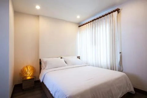 Bedroom with double bed in side of condominium. Stock Photos