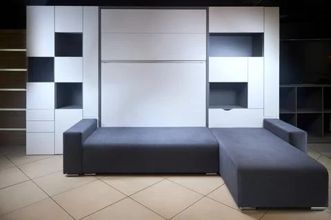 Bedroom interior flat with folded Vertical Murphy Wall Bed, roll-away pull out Stock Photos