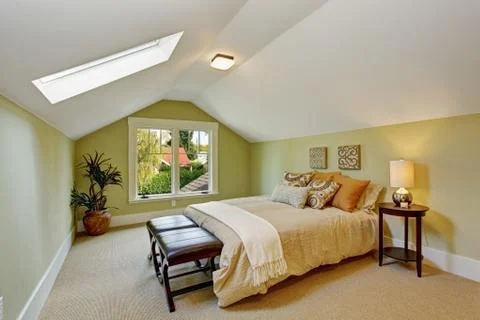Bedroom interior with vaulted ceiling and light mint walls Stock Photos