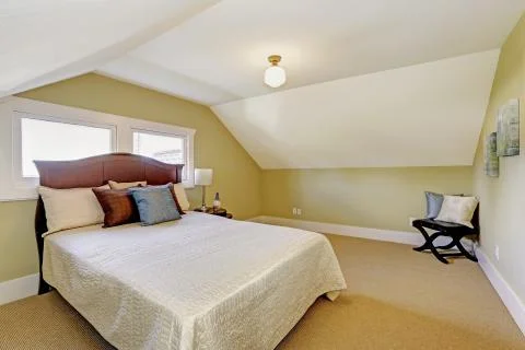 Bedroom interior with vaulted ceiling. Stock Photos