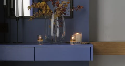 Bedroom vanity table with burning candles and flower vase. Modern minimalist Stock Footage 276134200