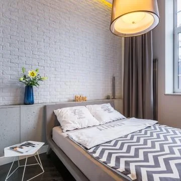 Bedroom with window and bed Stock Photos