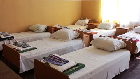 Beds and bedside tables in empty hospital room or a children's camp. Stock Footage 78767661