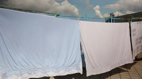 Bedsheets hung out to dry Stock Footage 64638562