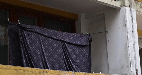 Bedsheets on an old balcony. Old eastern Europe building in 4k Stock Footage 165228168