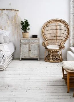 Bedside table and a chair next to the bed in a modern bedroom Foto stock
