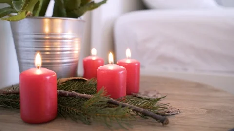 Bedside table with authentic Chrismas decoration and lit candles. Stock Footage 102656631