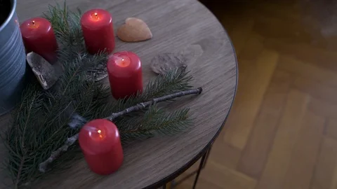 Bedside table with authentic Chrismas decoration and lit candles. Video stock 102657732