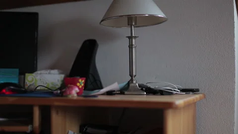 Bedside table with extinguished lamp typical of German home in summer. 库存影片 133587950