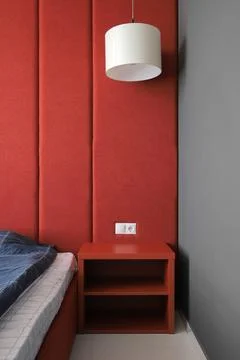 Bedside table near the bed in the bedroom Stock Photos