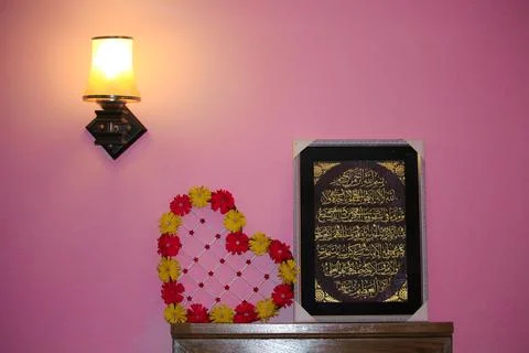 Bedside table overhead lamp that casts light &amp; shadow on the wall. Stock Photos