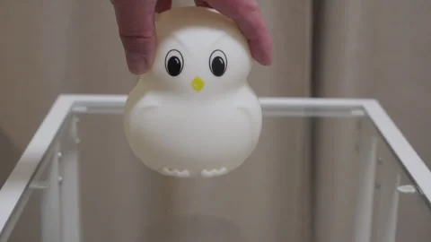 Bedtime Comfort: Soft Plastic Owl Nightlight Placed on Glass Table Gentle Tap. Stock Footage 321267324