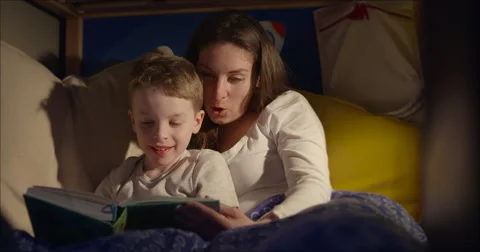 Bedtime reading mum and son travel 50fps Stock Footage 47004385