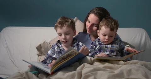 Bedtime story elder boy reading up loud  Stock-Footage 61265649