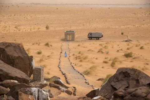 Beduin walking to stone flat near ancient neolithic village in the Sahara Stock Photos