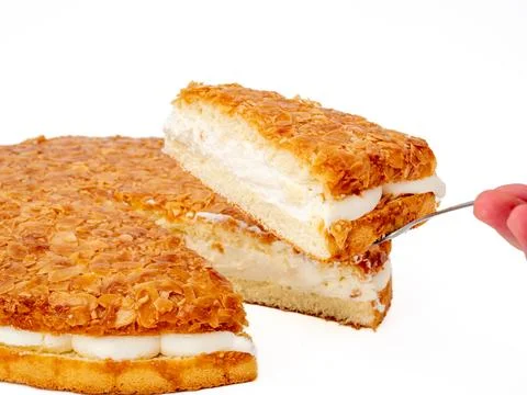 Bee sting cake, light cake with cream filling, with crispy almonds. Stock Photos