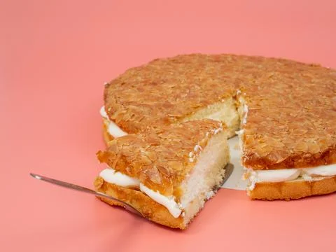 Bee sting cake, light cake with cream filling, with crispy almonds. Stock Photos
