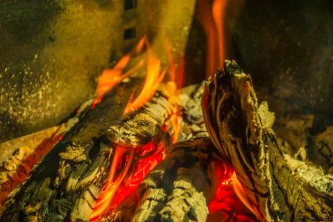 Beech log burning in barbecue with nice warm yellow flame Stock Photos