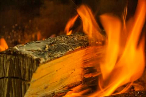 Beech log burning in barbecue with nice warm yellow flame Stock Photos