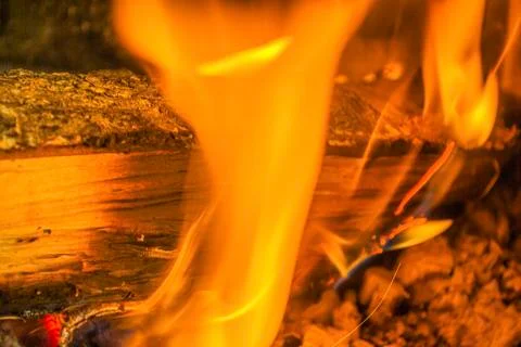 Beech log burning in barbecue with nice warm yellow flame Stock Photos