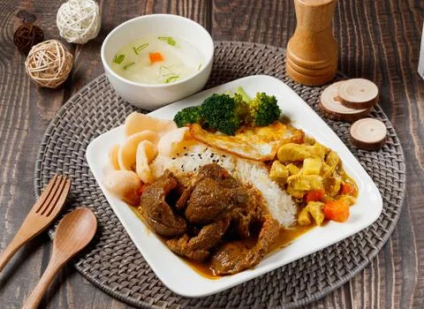 Beef and Chicken Double Rice served in dish isolated on table side view of ta Stock Photos