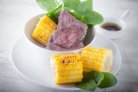 Beef and grilled corn Stock Photos
