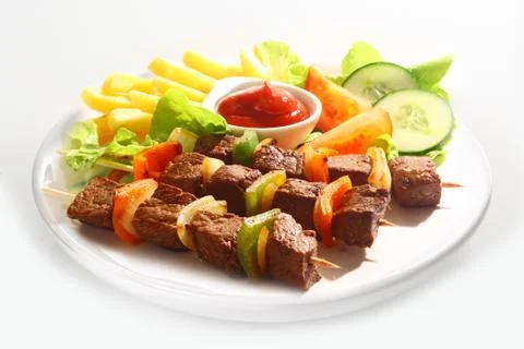 Beef and pepper kebabs with salad Stock Photos