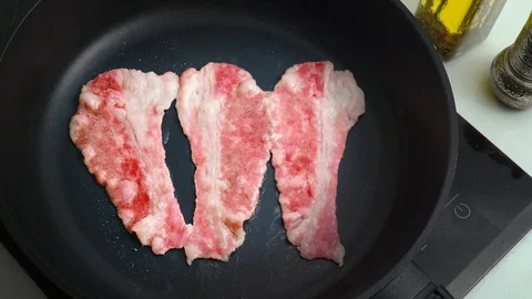 Beef bacon frying in a pan marbled thin beef Stock-Footage 124134640