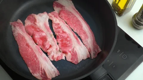 Beef bacon frying in a pan marbled thin beef Stock Footage 124134869