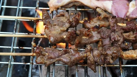 Beef barbeque was skewered on bamboo sticks and grill on stove. Stock Footage 105023668
