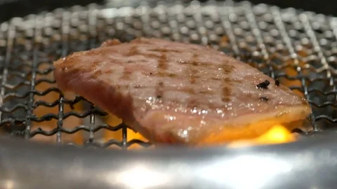 Beef with beautiful marble fat grilled in grilling basket Stock Footage 83149079