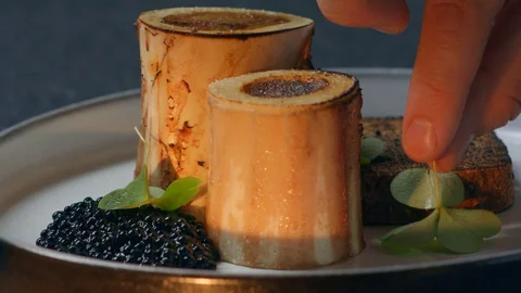Beef bone black caviar and shamrock luxury food in an expensive restaurant Stock-Footage 129569329