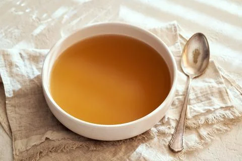 Beef bone broth in a bowl on a table Foto stock