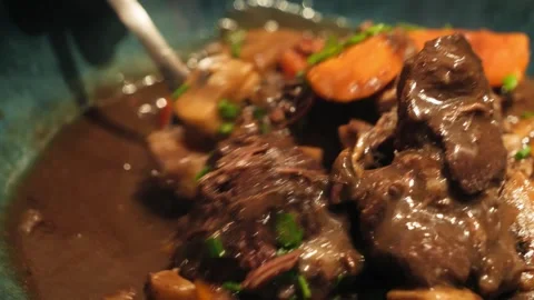 Beef Bourguignon is a classic French dish of beef braised in a rich sauce of red Stock Footage 334138549