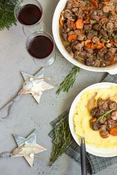 Beef bourguignon or meat stew with vegetables and herbs in a casserole. Stock Photos