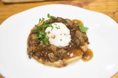 Beef bourguignon vol au vent with poached egg and herbs Stock Photos