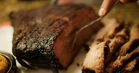 Beef brisket Man carving thin slices of roast beef Stock Footage 86295719