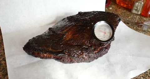 Beef brisket Portion of roasted meat with a temperature gauge Stock Footage 86293117