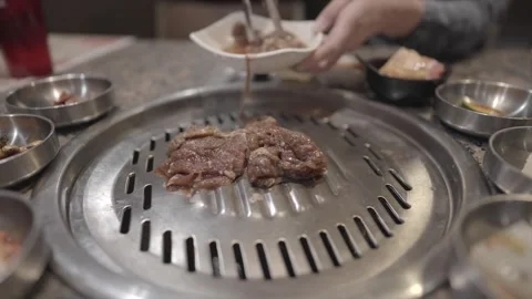Beef bulgogi placed on k bbq grill Stock Footage 305791586