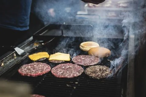 A beef burger bbq on a grill Stock Photos