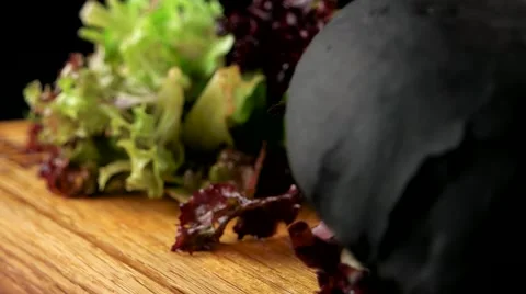 Beef burger with a black bun, French fries and salad on the wooden board Video stock 66480341