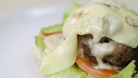 Beef Burger with Cheese Melting on Top Stock Footage 166862901