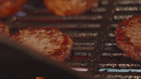 Beef Burger Flipped on Hot BBQ Grill. Outdoor Summer Night Cooking. 動画素材 342268902
