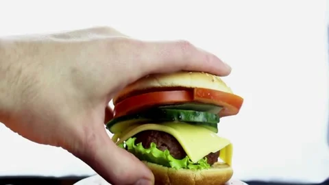 Beef burger hand grabbing on the black plate background. 4K UHD video Video stock 336579177