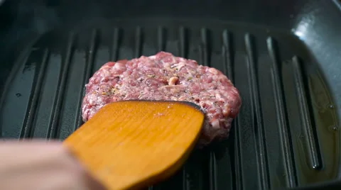 Beef burger patties grilling on a griddle pan Stock Footage 65757761