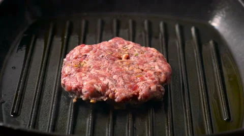 Beef burger patties grilling on a griddle pan Stock Footage 65758112