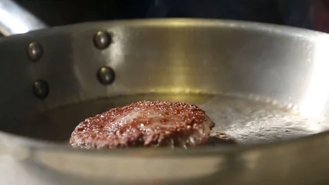 Beef Burger Patty fried in a steel pan Stock Footage 101753607