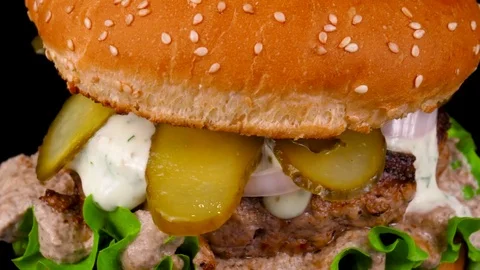 Beef burger with pickled cucumbers, mushroom sauce and mayonnaise Stock Footage 84652865