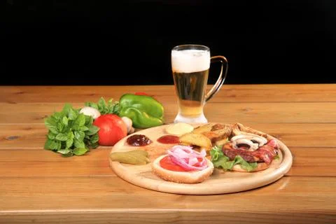 Beef burger on a plate with vegetables Stock Photos